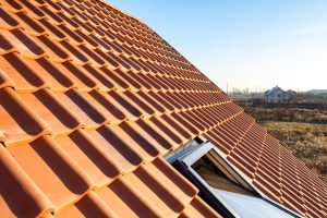 Overlapping rows of yellow ceramic roofing tiles