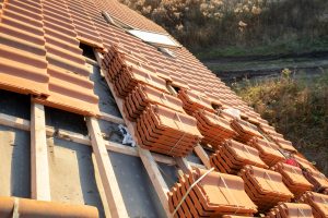 Stacks of yellow ceramic roofing tiles for covering residential