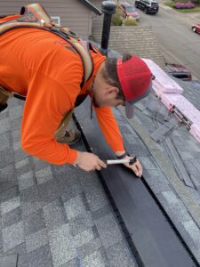 man installing roofing