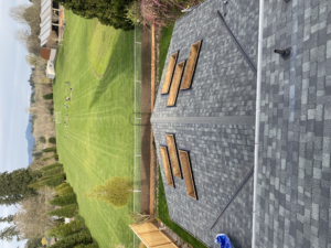 freshly installed roof next to a green field