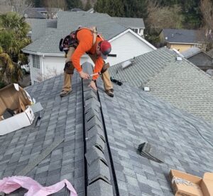 man working on roof peak