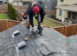 man installing roofing