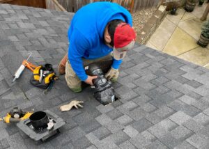 man installing roof vents